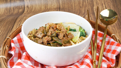 Indonesian food, mie ayam, noodles with chicken. Served in bowl. Selective focus.