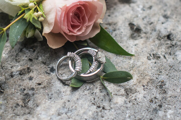 Wedding band placed on coral rock and flowers