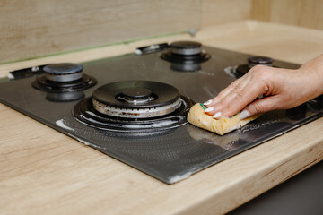 the person washes the stove