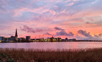 sunset over the city of rostock, beautiful colored evening sky 