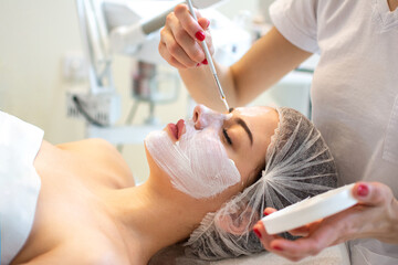 Peeling mask application. Spa beauty organic facial mask application at day spa salon.