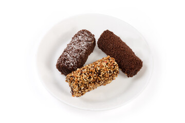 Small soft chocolate cakes with different sprinkling on white dish