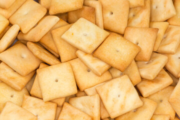 Heap of the salty crackers, top view close-up