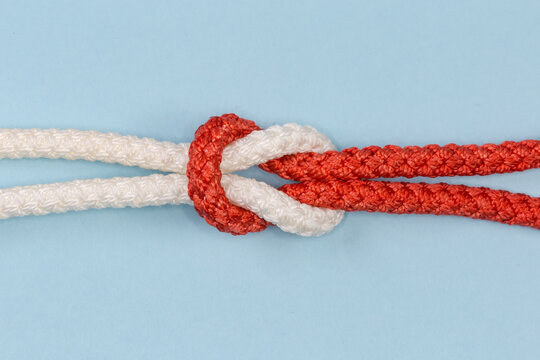 Rope reef knot close-up on a blue background
