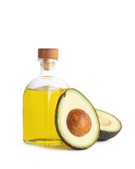 avocado oil in a glass jar and a ripe cut avocado on a white isolated background