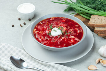 Ukrainian vegetarian borscht with beans on a gray background