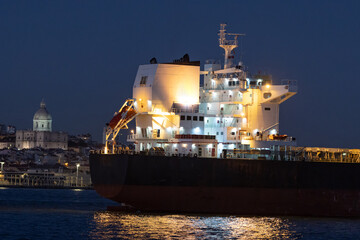 Bright lights on an industrial vessel in the evening