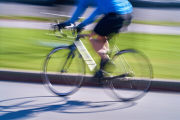 Motion Blur of Moving Bicycle. A slow-shutter blur of a bicycle rider on an urban street. 

