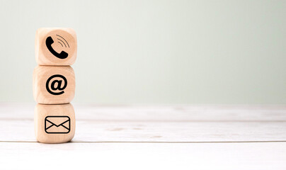 Contact Methods. Close-up of a phone, email, chat and post icons wooden block.