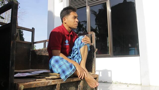 Asian Young Man Sitting While Practicing Voice Vocals For A Theater Performance