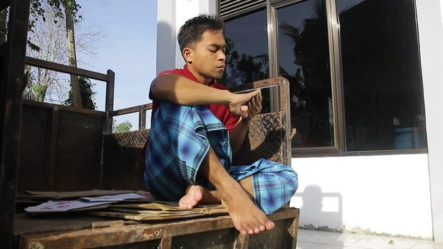 Asian Young Man Sitting While Practicing Voice Vocals For A Theater Performance