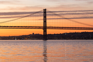 Lisbon and 25th of April Bridge at sunset