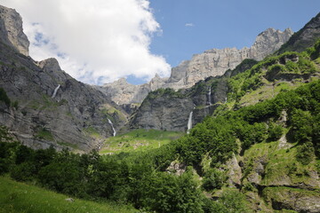 View on a waterfall in the Cirque du Fer-à-Cheval which is a natural circus of France located in the territory of the commune of Sixt-Fer-à-Cheval, in the department of Haute-Savoie