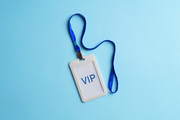 Plastic vip badge on light blue background, top view