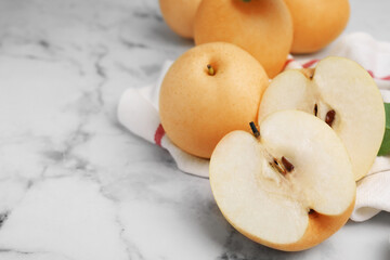 Delicious apple pears on white marble table, closeup. Space for text