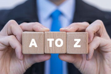 Businessman holding wooden cubes with inscription: A TO Z. A TO Z business education concept.