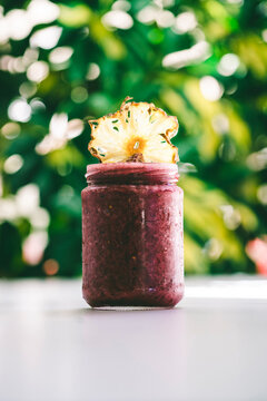 Close-up of pineapple slice on preserves in jar at table