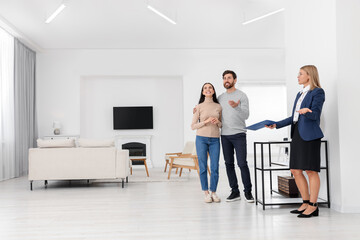 Real estate agent showing new apartment to couple