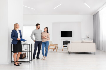 Real estate agent showing new apartment to couple