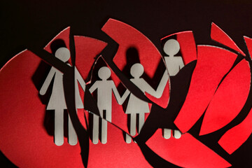 Human figures reflected in broken mirror on black background. Divorce concept
