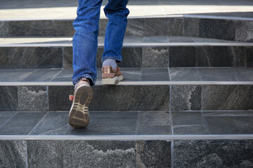 Fototapeta na wymiar Woman walking up stylish stone stairs outdoors, closeup