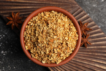 Bowl of dried orange zest seasoning, fresh fruit and anise on grey table, flat lay