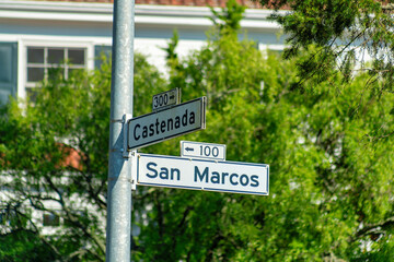Whit and black road sign in the historic districts of san francisco california that says san marcos street and castenada