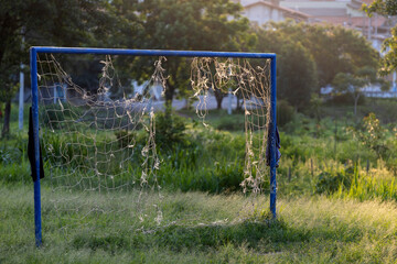 Empty soccer football net on the field in countryside of Sao Paulo state, Brazil with evening sun © Casa.da.Photo