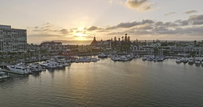 San Diego California Aerial v103 cinematic low flyover glorietta bay and famous beachfront hotel del coronado at sunset golden hour, romantic hollywood scene - Shot with Mavic 3 Cine - September 2022
