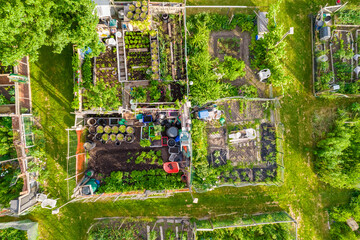 Community garden prepared for vegetables and fruits farming, aerial view of urban farms near...