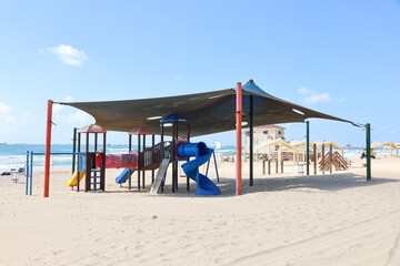 Children's playground with slide on beach