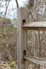 Barrier for cattle or horses of old wood in autumn winter, with art in wood and carvings, sky blue