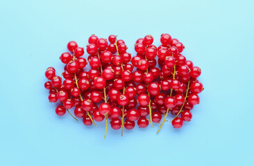 Heap of ripe red currant on color background