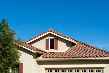 Tiled roof and attic window of a suburban single-family residence, Oasis Community, Menifee,...