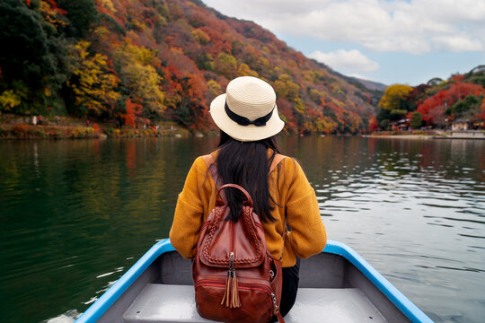 Travel woman sit on travel boat in river at arashiyama