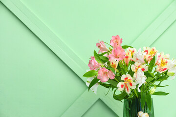 Vase with beautiful alstroemeria flowers near color wall. Mother's day celebration