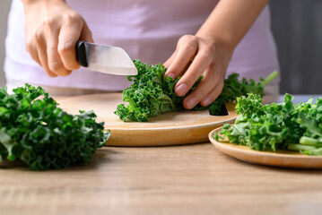 Green Kale or leaf cabbage cutting on wooden board, Healthy vegetable