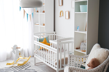 Stylish interior of children's room with baby bed