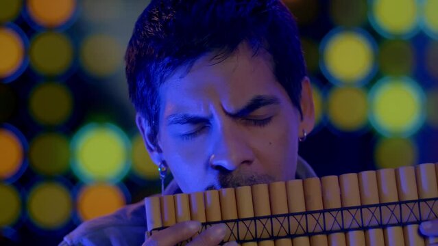 Close Up Shot Of Musician Playing Pan flute Instrument From Andes Of Peru And Bolivia