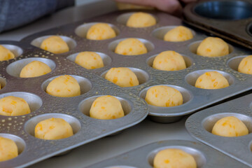 Preparation and baking of Brazilian cheese buns traditionally used as snack are homemade