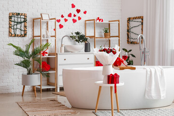 Interior of bathroom decorated for Valentine's Day with flowers, gifts and hearts