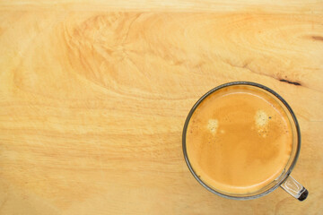 glass of hot black coffee put on wood background