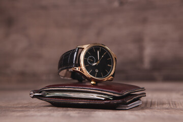 wrist watch and wallet on the table