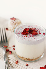 Rose pink vegan cheesecake in a glass cup dessert