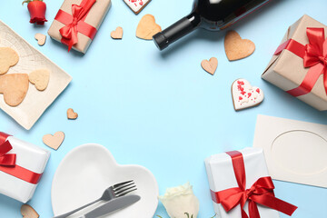 Frame made of gifts for Valentine's Day celebration, cookies, plate and bottle of wine on color background