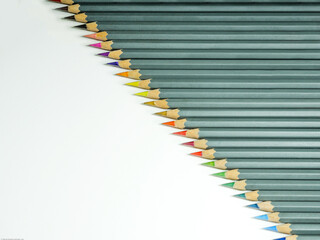 Gray pencil with colored tips isolated diagonally to the right on a white background