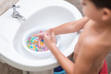 Happy boy - playing with the orbeez balls
