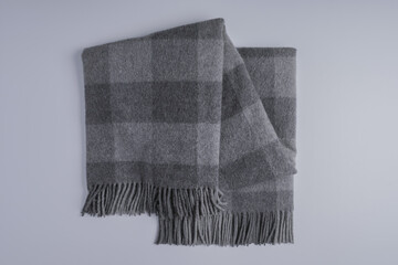Folded checkered gray throw blanket