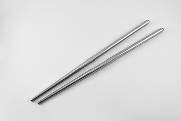 Metal chopsticks isolated on white background. Stainless steel chopsticks