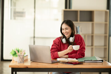 businesswoman holding coffee cup talking on the phone. Happy to work.